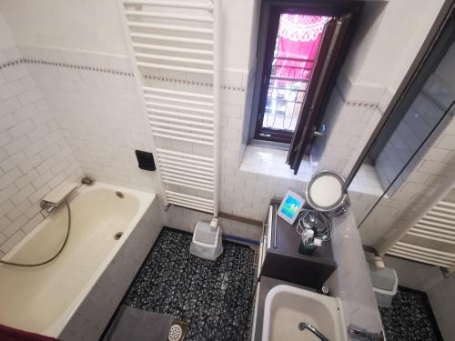 a small bathroom with a tub and a sink at Rozica in Idrija