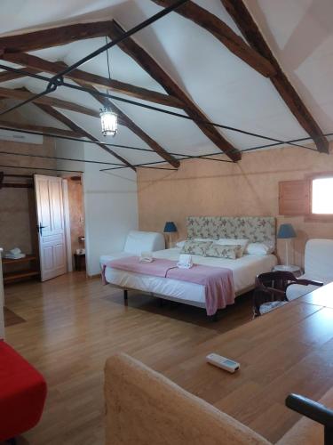 a bedroom with a large bed in a room at Casa Rural El Simarro in El Simarro
