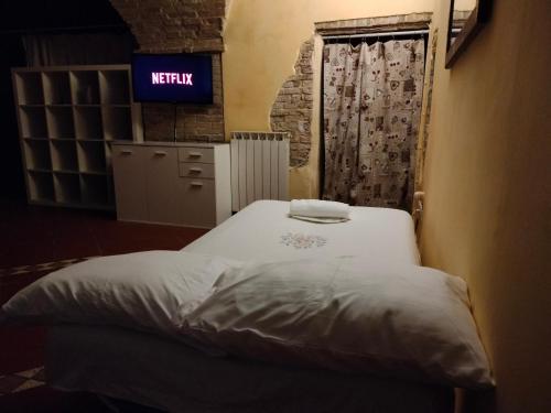 a bed in a room with a sign on the wall at [Perugia Center] Typical apartment in Perugia