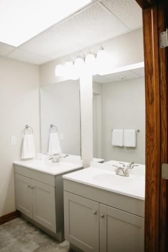 a bathroom with two sinks and a large mirror at Bricktown Inn in Camp Point