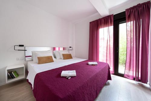 a bedroom with a large bed with two towels on it at Sea Melody in Lopar