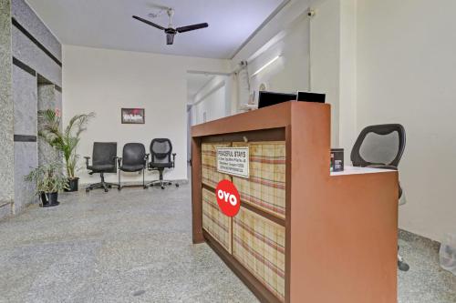 an office with a desk with a stop sign on it at OYO Flagship Hotel Stanley Falls in Gurgaon