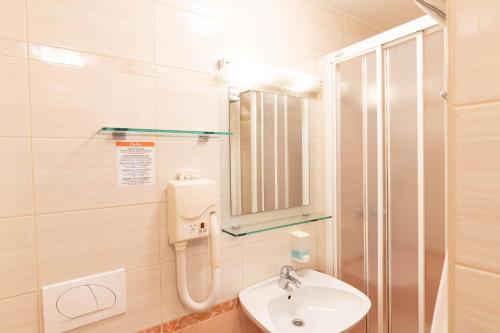 a bathroom with a sink and a shower at Apartmaji in sobe RaMar in Straža