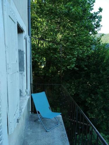a blue chair sitting on the porch of a house at Villa des Lucioles 2 in Annot