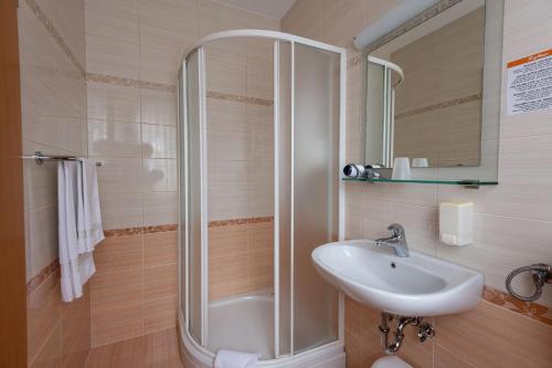 a bathroom with a shower and a sink at Apartmaji in sobe RaMar in Straža