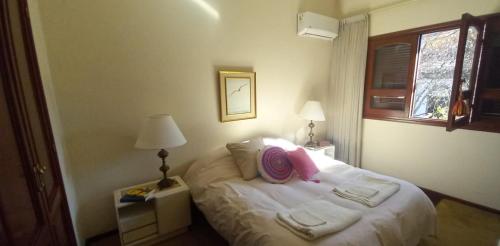 a bedroom with a bed with towels on it at Mi habitación en Salta cerca de todo ! in Salta