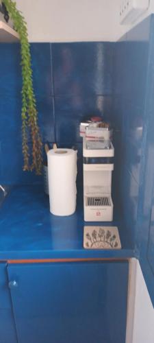 a blue counter with a bucket and other items on it at Mana mia Seaside Apartments in Leptokaria