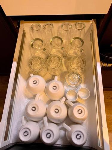 a drawer filled with glass jars and vases at Sluwe Vos: ontspannen in het bos! in Otterlo