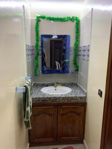 a bathroom with a sink and a mirror at Villa in Douar Ourlali
