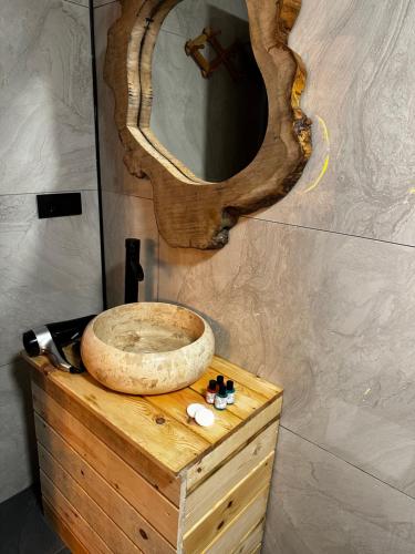 a sink on top of a wooden dresser with a mirror at Ria süit otel bungalov in Rize