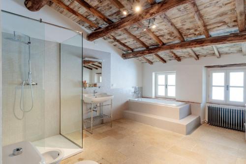 a bathroom with a shower and a tub and a sink at Palazzo Giusti, Understated Luxury with a Welcoming Ambience on the Hills of Lucca in Pescaglia