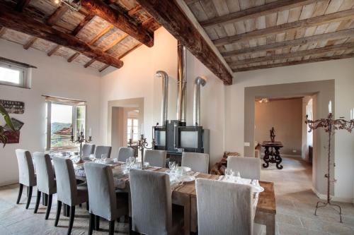 a large dining room with a long table and chairs at Palazzo Giusti, Understated Luxury with a Welcoming Ambience on the Hills of Lucca in Pescaglia