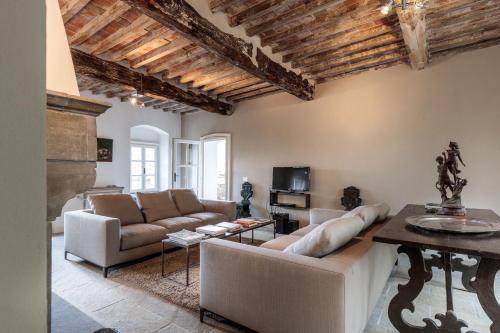 a living room with a couch and a table at Palazzo Giusti, Understated Luxury with a Welcoming Ambience on the Hills of Lucca in Pescaglia