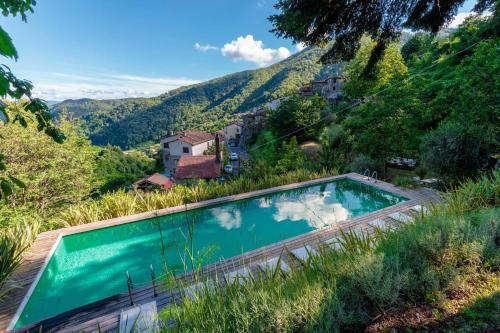 a swimming pool with a view of a mountain at Palazzo Giusti, Understated Luxury with a Welcoming Ambience on the Hills of Lucca in Pescaglia