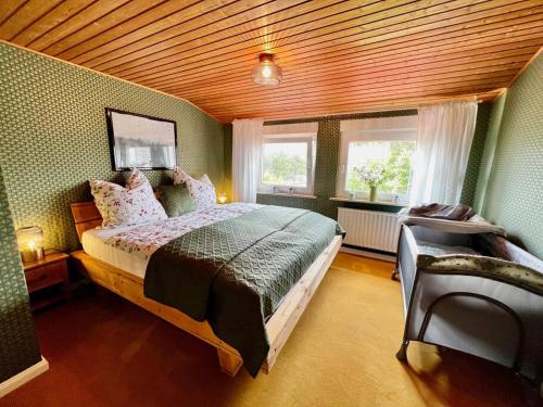 a bedroom with a large bed and a window at Fewo Plüschmors in Dornum