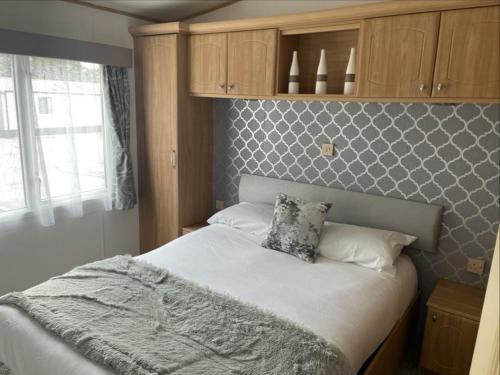a bedroom with a large bed with white sheets at Pendle Hill View in Preston