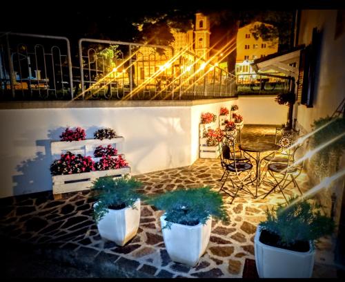 a patio with potted plants on a balcony at night at B&B COLLE TARIGNI in Manoppello