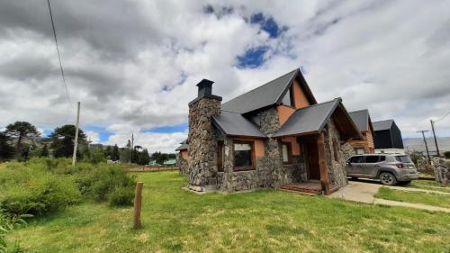 a stone house with a car parked in front of it at Antu in Caviahue