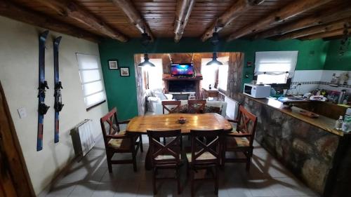 a dining room with a wooden table and chairs at Antu in Caviahue