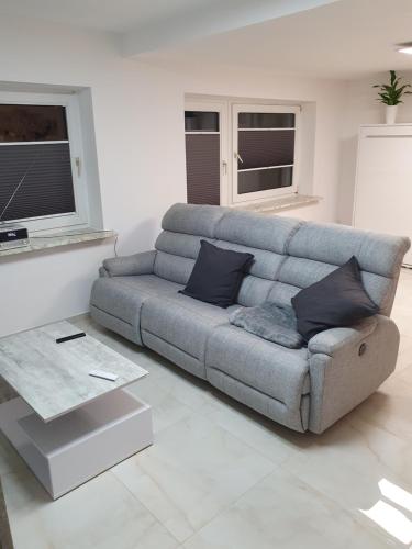 a living room with a couch and a table at Mikes Fewo in Hohegeiß