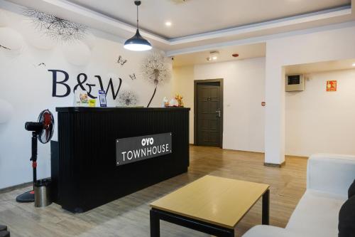 a living room with a tv and a table at Townhouse 1118 The B&W Motel in Visakhapatnam