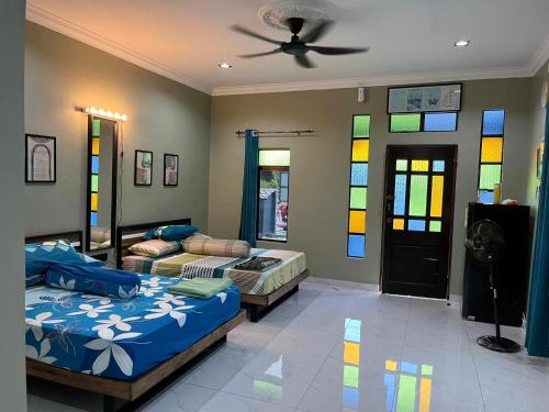2 letti in una camera con vetrate istoriate di Rumah Armand Studio Family with Swimming Pool Pengkalan Balak Tg Bidara Masjid Tanah Melaka a Kampong Ayer Hitam Ulu