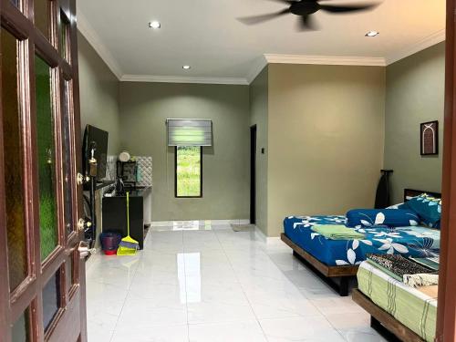 a bedroom with a bed and a ceiling fan at Rumah Armand Studio Family Suite with Swimming Pool Pengkalan Balak Tg Bidara Masjid Tanah Melaka 