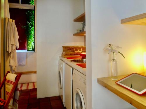 a kitchen with a sink and a washing machine at Heaven AT 11, your Deluxe Studio with personal bathroom, kitchenette & terrace in Ghent