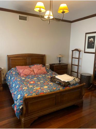 a bedroom with a bed with a blue comforter at Quinta de Santo António in Fonte Bastardo