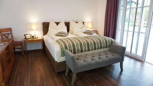 a bedroom with a bed and a chair and a window at Villa Eisl-Raudaschl in St. Wolfgang