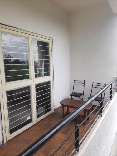 a balcony with a bench and a window at Solapur HomeStay By Stay Nestura in Solapur