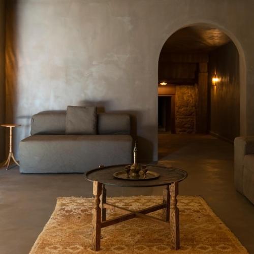 a living room with a table and a couch at Life Gallery Hotel & Spa in Korçë