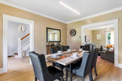 a dining room with a table and chairs at Modern Oakley Retreat - King Bed - Free Parking - Centrally Located in Cincinnati