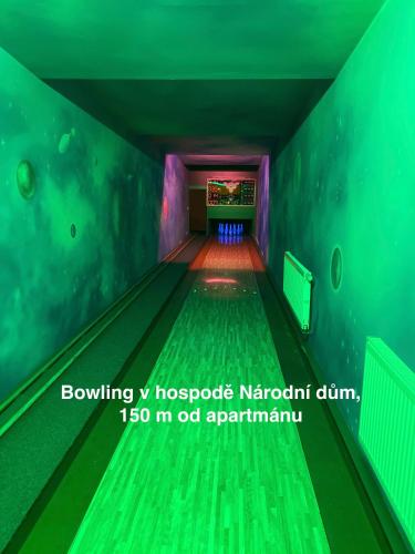 a bowling alley with green lanes in a pool at Apartmány Havířská Žacléř, Krkonoše in Žacléř