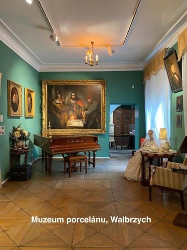 a room with a painting on the wall and a piano at Apartmány Havířská Žacléř, Krkonoše in Žacléř
