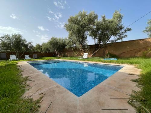 a swimming pool in the backyard of a house at Douja Ferme in Ouirgane