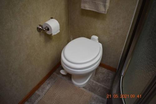 a bathroom with a toilet and a roll of toilet paper at Stay at our place in Wine Country! in Zillah