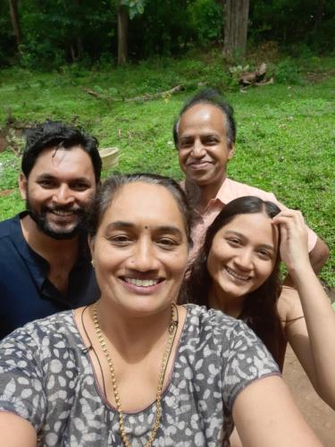 a group of three people posing for a picture at Wild Window - Forest View Homestay in Thekkady