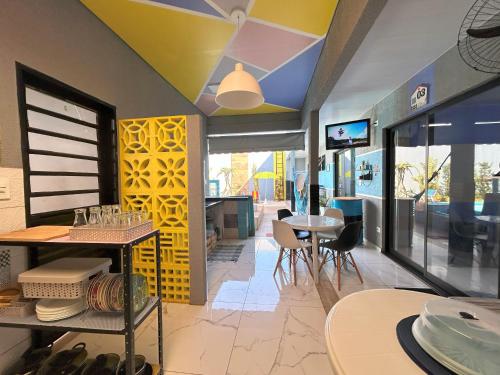 a restaurant with tables and chairs in a room at Hostel Quintal de Casa in Foz do Iguaçu