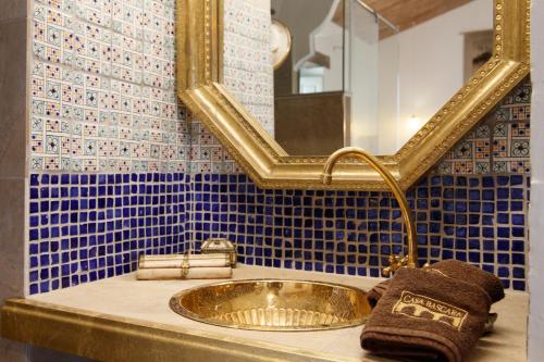 a bathroom with a gold sink and a mirror at Casa bascara in Báscara
