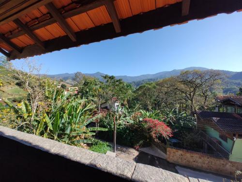 a view from the balcony of a house with mountains in the background at Pousada Solar das Flores Maringá RJ Visconde de Mauá in Visconde De Maua