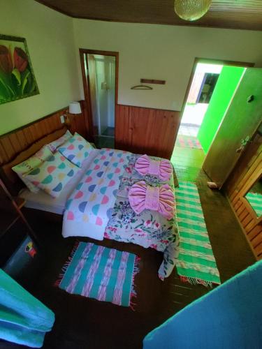 A bed or beds in a room at Pousada Solar das Flores