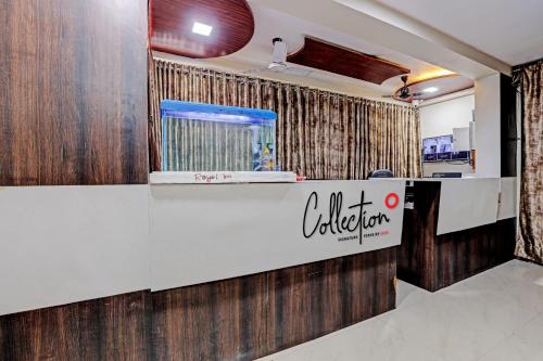 a restaurant with a counter with a fish tank at Collection O Hotel Royal Inn in Ahmedabad