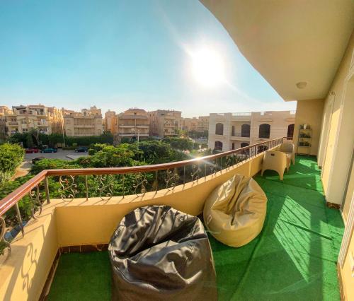 a balcony with two bean bag chairs and a view of a city at 3BD apartment in family house with private garden view in Cairo