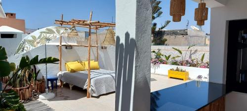 a bedroom with a canopy bed on a balcony at CASA ZOUINA in Agadir