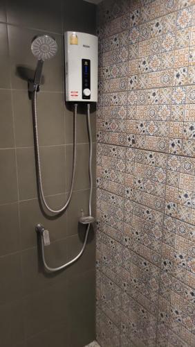 a shower in a bathroom with a phone on the wall at Apple's La casita condo Hua Hin room2 in Hua Hin