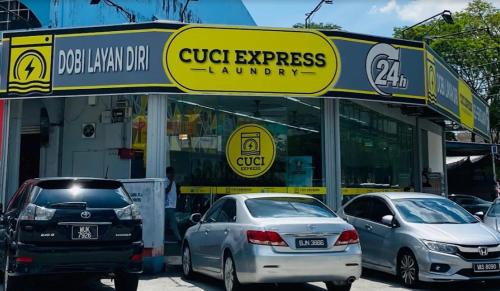 two cars parked in front of a car dealership at USJ Subang Jaya Sunway Paradise Home Staycation-PH1346 in Subang Jaya