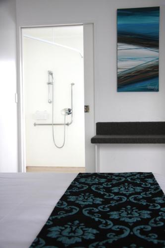 a room with a door with a black and white rug at Camelot On Ulster in Hamilton