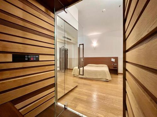 a bedroom with a bed and a sliding glass door at Hotel Lovere Resort & Spa in Lovere