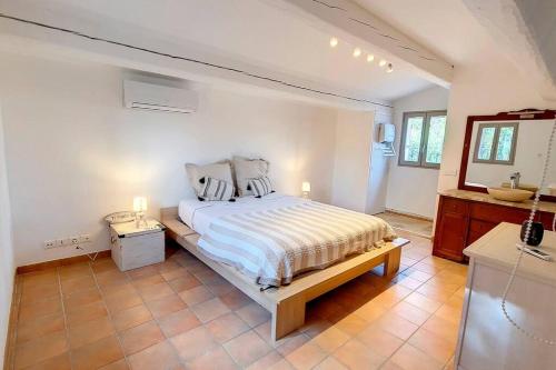 um quarto branco com uma cama e um lavatório em Aux trois Cyprès Salernes en Provence em Salernes